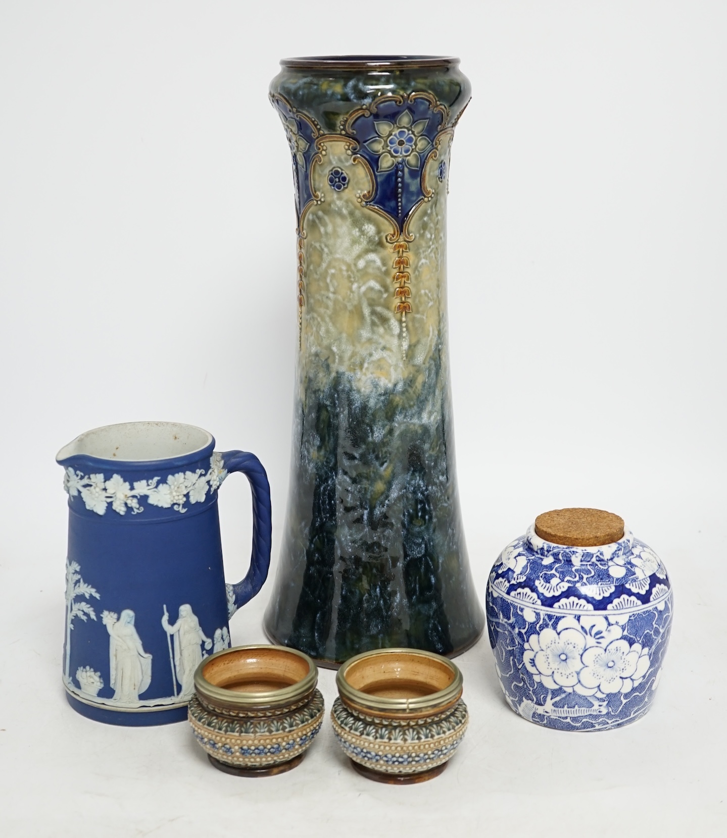 Five ceramic items comprising Doulton vase, two miniature Doulton pots, a Wedgwood jug and a blue and white jar, largest 33cm. Condition - two pots poor, others good